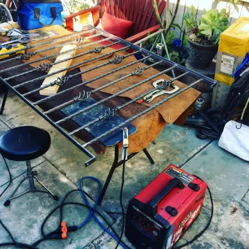 Professional fence repair specialist working on damaged metal fencing