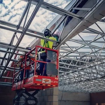 Professional welder performing onsite welding with sparks flying in industrial setting