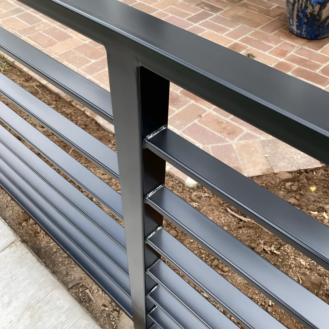 Beautiful custom pool fence with safety gate around modern swimming pool