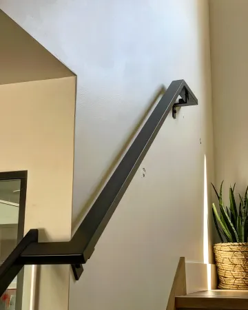 Elegant glass railing installation on modern staircase with metal posts