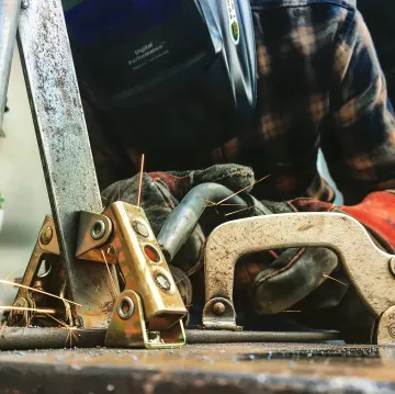 Close-up of pristine TIG weld on stainless steel railing showing precision craftsmanship