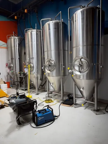 Professional welder working on industrial steel fabrication project