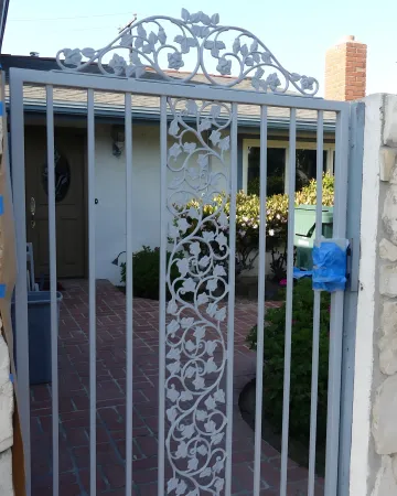 Skilled welder crafting custom wrought iron gate components