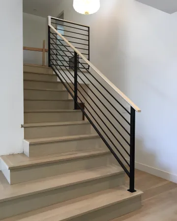 Skilled welder fabricating custom wrought iron railing components