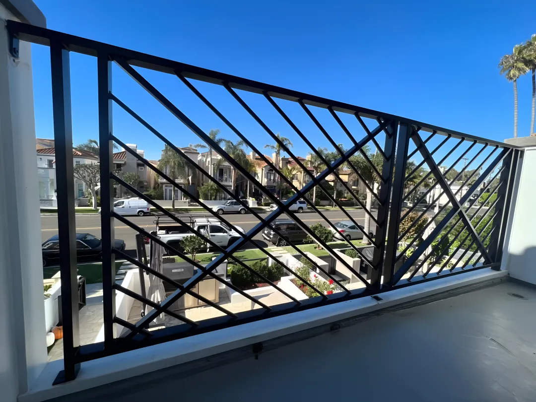 Artisan welding custom wrought iron railing with detailed scrollwork