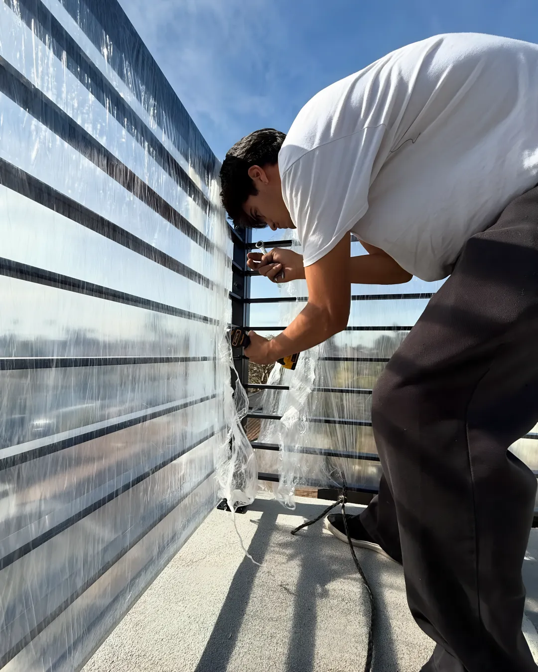 Custom wrought iron railing installation process showing welding work