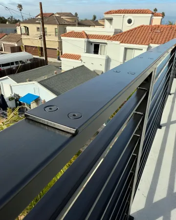 Artisan welding custom wrought iron railing with decorative scrollwork