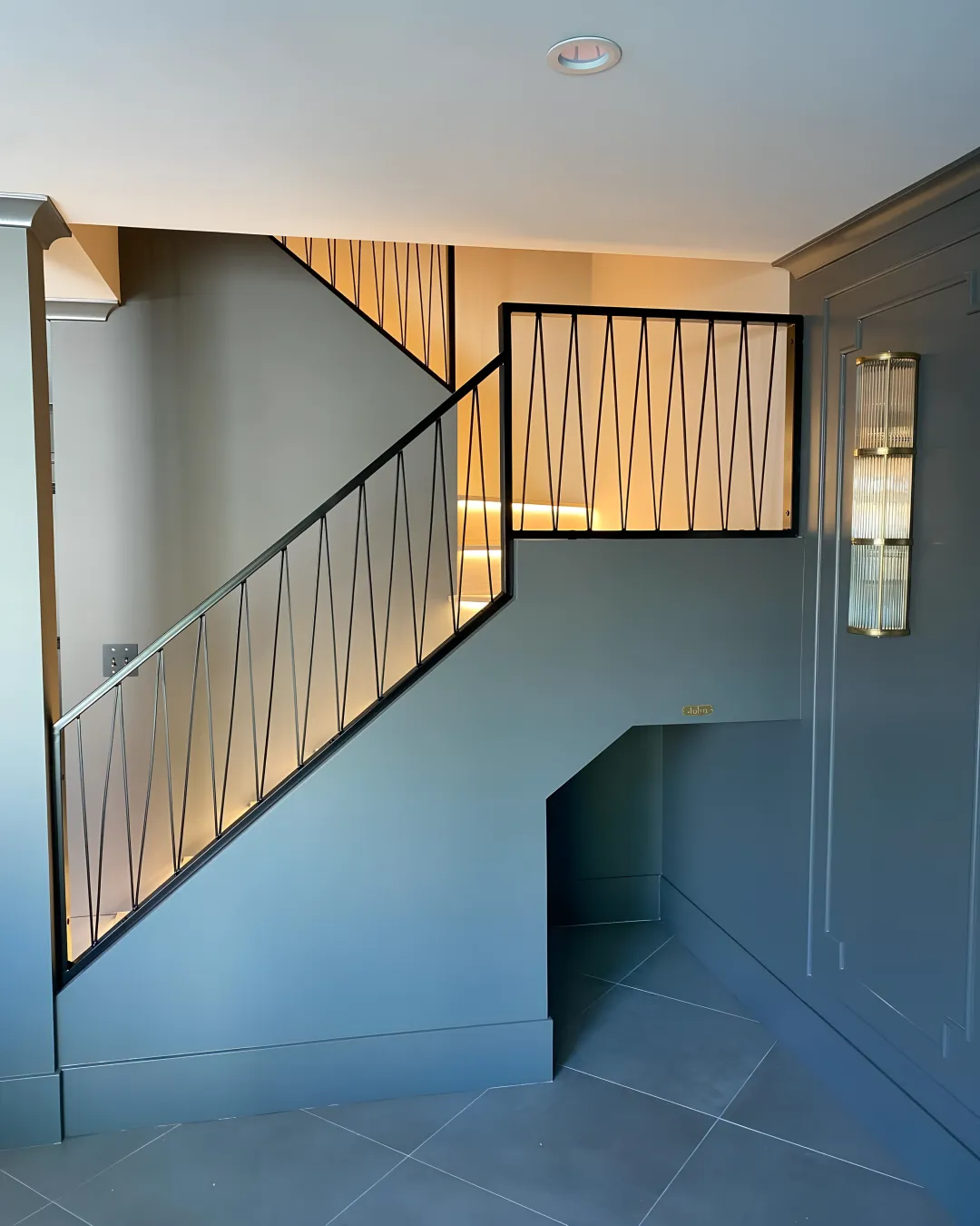 Custom wrought iron staircase with wood treads being installed