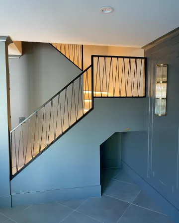 Custom wrought iron staircase with wood treads being installed