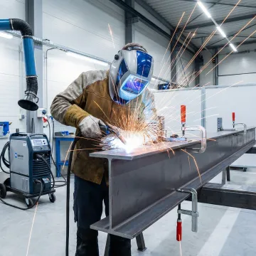 Professional welder performing precision structural steel welding in Westminster industrial facility