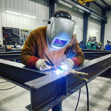 Professional welder performing precision TIG welding on custom structural steel in Costa Mesa workshop