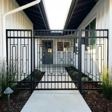 Custom wrought iron gate with modern design elements and ornamental details