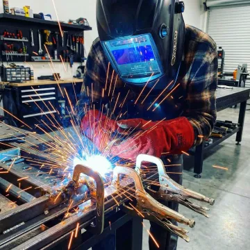 Professional welder creating custom metal fabrication in Garden Grove workshop
