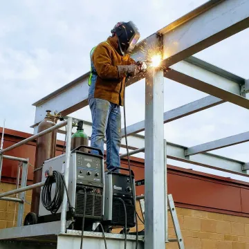 Professional welder performing mobile welding service on metal structure in Laguna Niguel