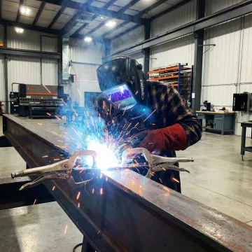 Professional welder performing industrial steel fabrication work in Irvine facility