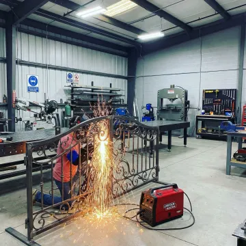 Professional welder working on custom metal fabrication in Placentia workshop