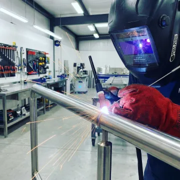 Professional welder working on custom metal fabrication in Dana Point workshop