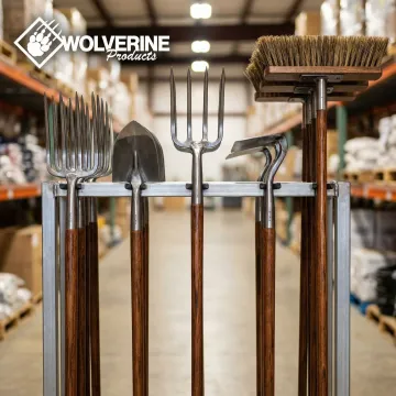 Close-up of Wolverine forged steel professional landscape tools displayed in a warehouse setting