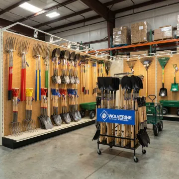 Professional lawn and garden hand tools displayed in a wholesale supply warehouse setting