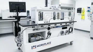 Gas chromatography instrument bench with integrated carrier gas routing and vacuum pump enclosure