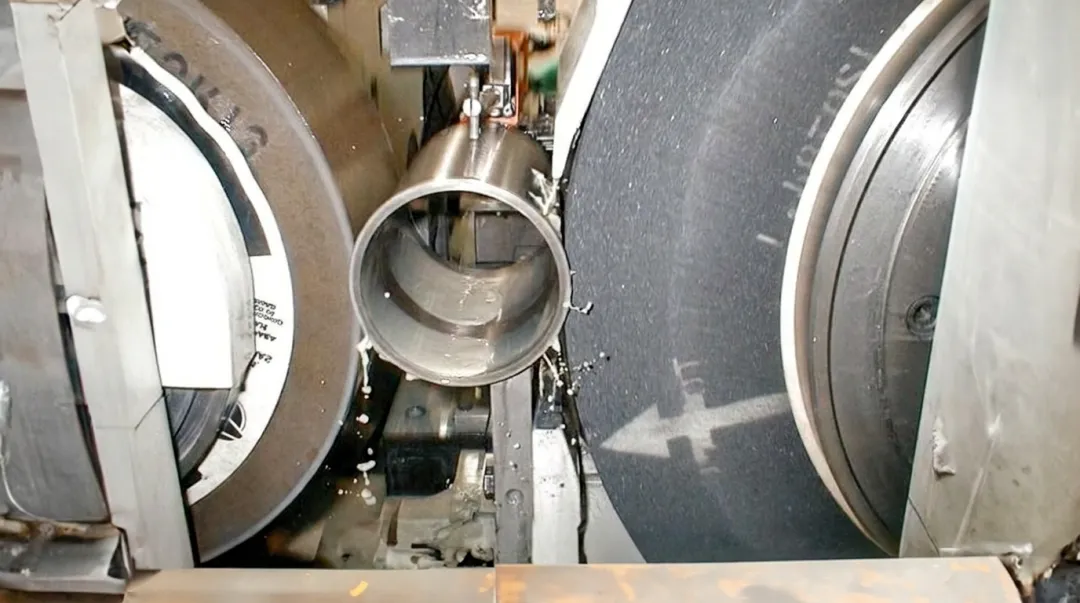 Centerless grinding machine in operation producing high-volume precision cylindrical components