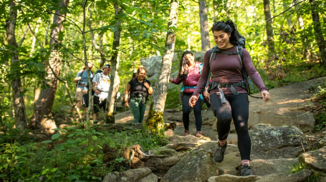 Corporate team hiking outdoors on a guided nature trail retreat activity
