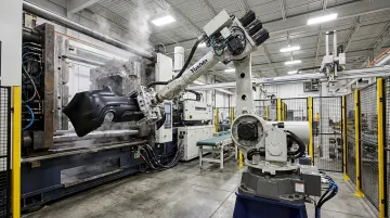 Yushin robotic take-out system operating on large automotive injection molding press