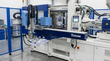 Yushin servo take-out robot removing precision optical part from ICM press