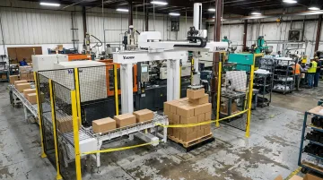 Yushin PA Series compact palletizing robot stacking boxes at end-of-line