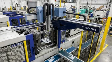 Yushin servo-driven take-out robot extracting molded parts on injection molding machine