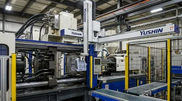Yushin take-out robot extracting molded parts from injection molding machine mold