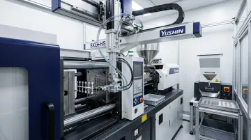 Yushin SXC side-entry robot extracting micro parts from compact injection molding cell