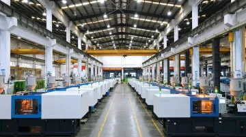 High-volume plastics injection molding production floor with multiple active machines