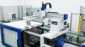 Compact servo take-out robot removing parts from small injection molding press