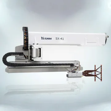 Technician monitoring automated injection molding robot