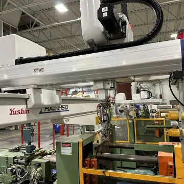 Technician programming injection molding robot