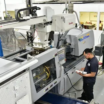 Precision injection molding robot and tooling in production