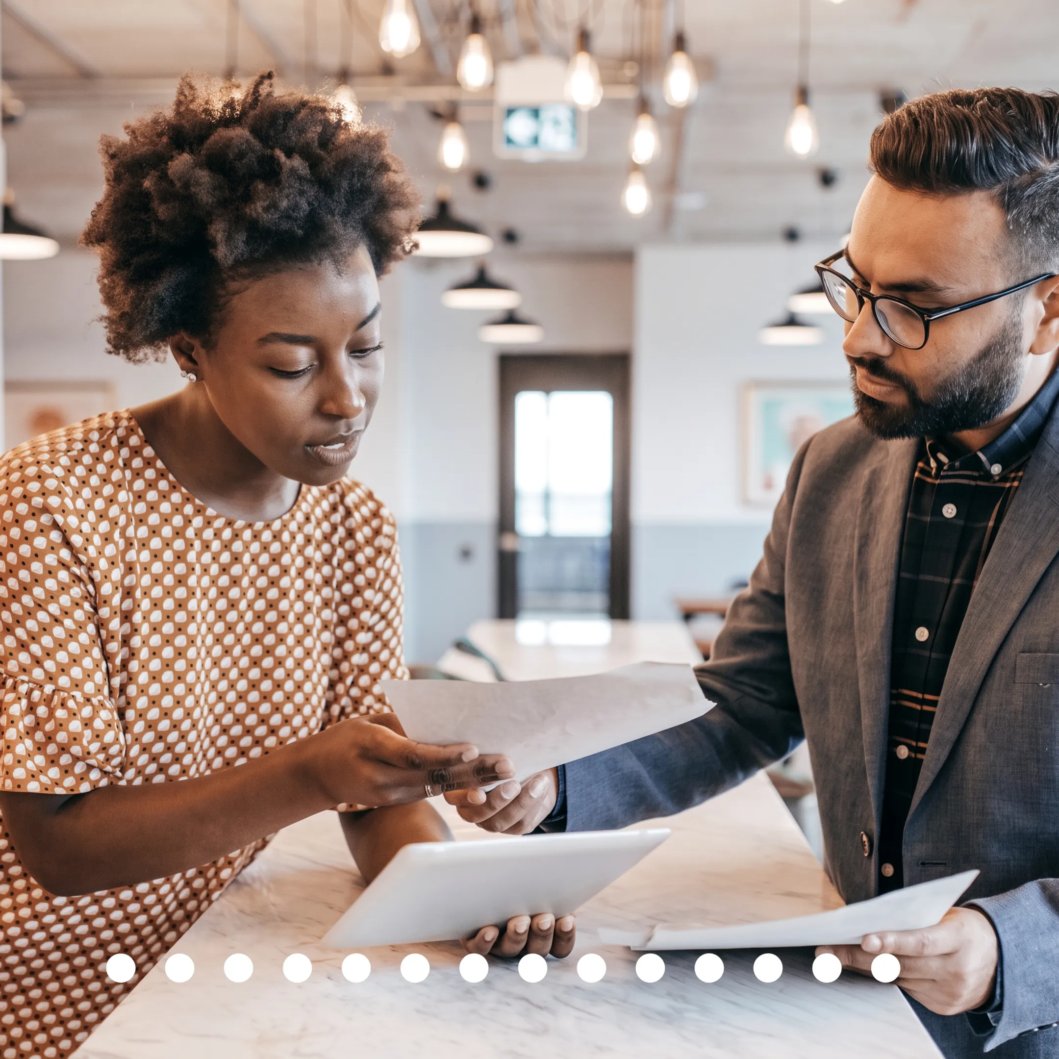 Tax professional explaining financial planning documents to a business owner