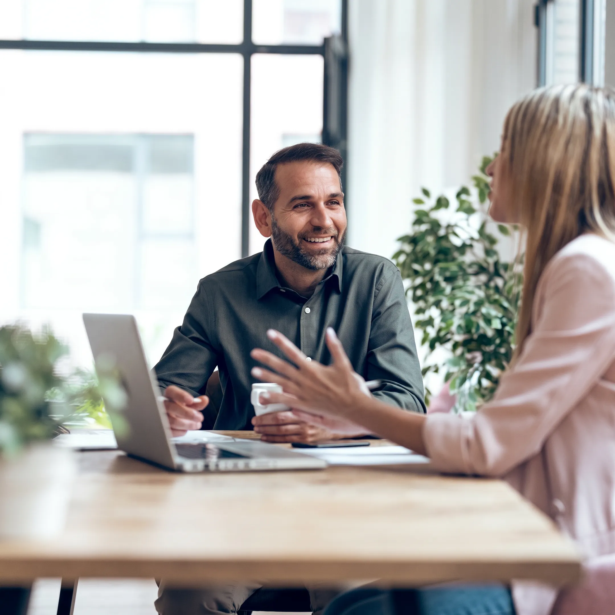 Accountant reviewing startup financial reports with a founder at a modern office desk
