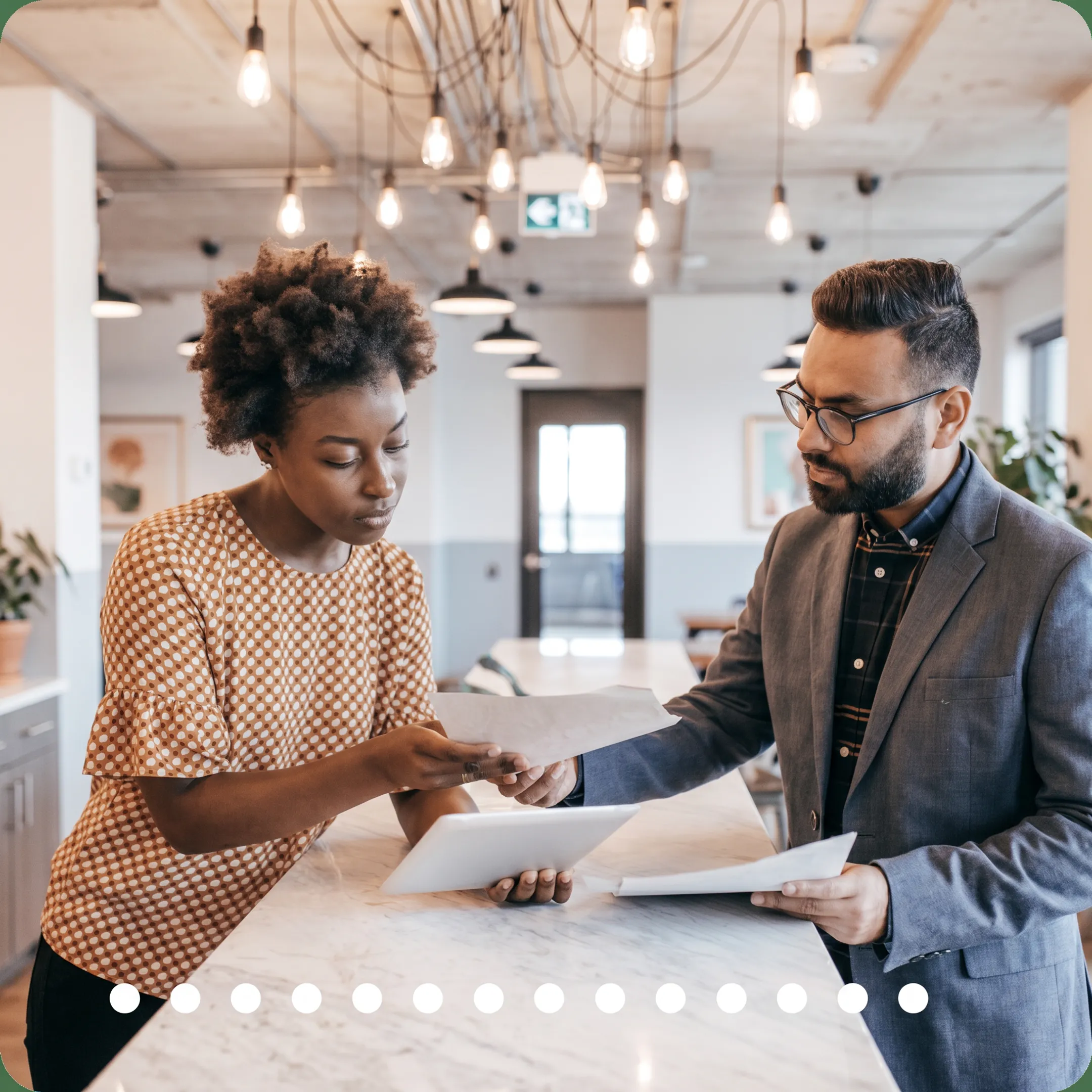 Tax professional explaining financial reports and tax planning to a business owner