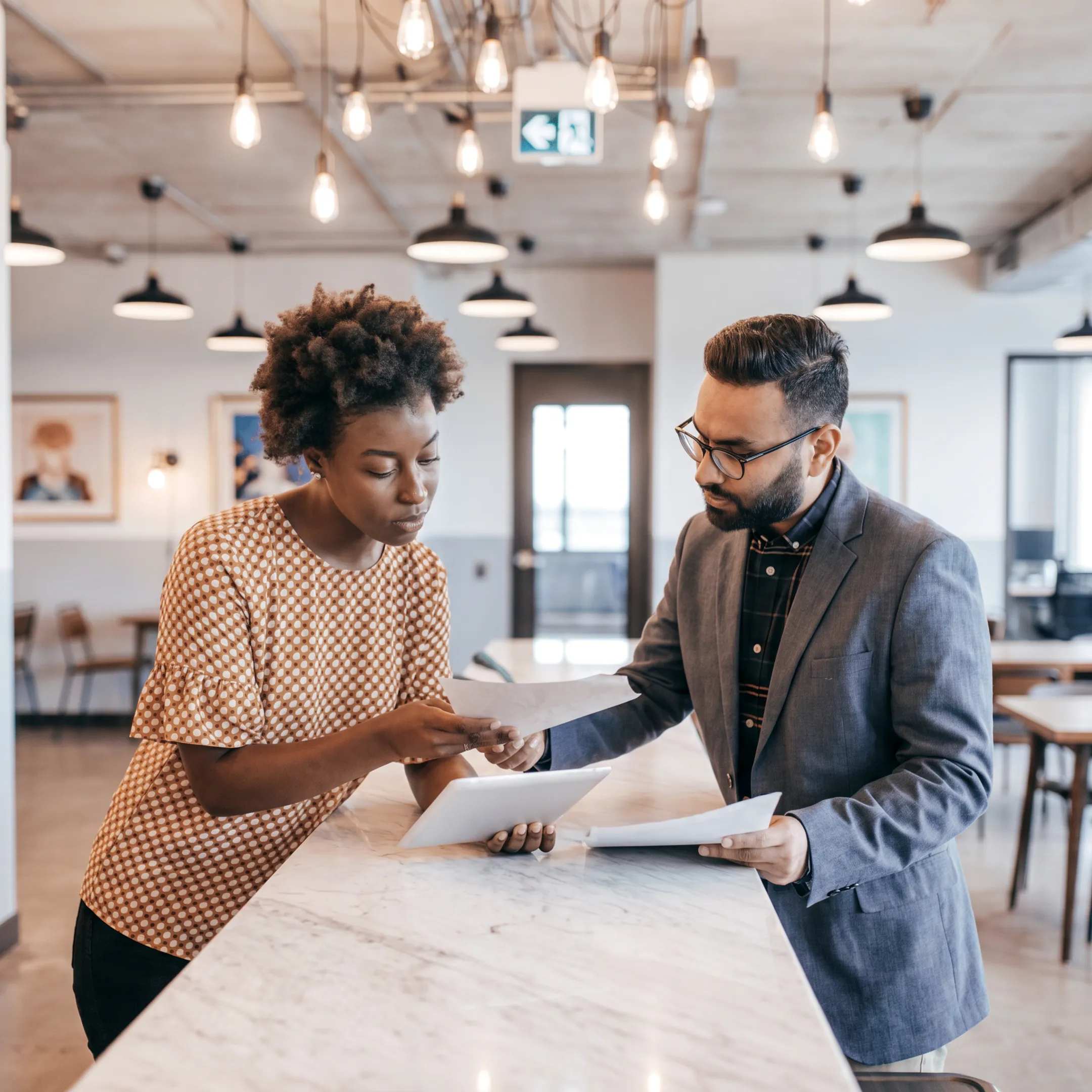 Tax advisor explaining financial planning documents to a business owner