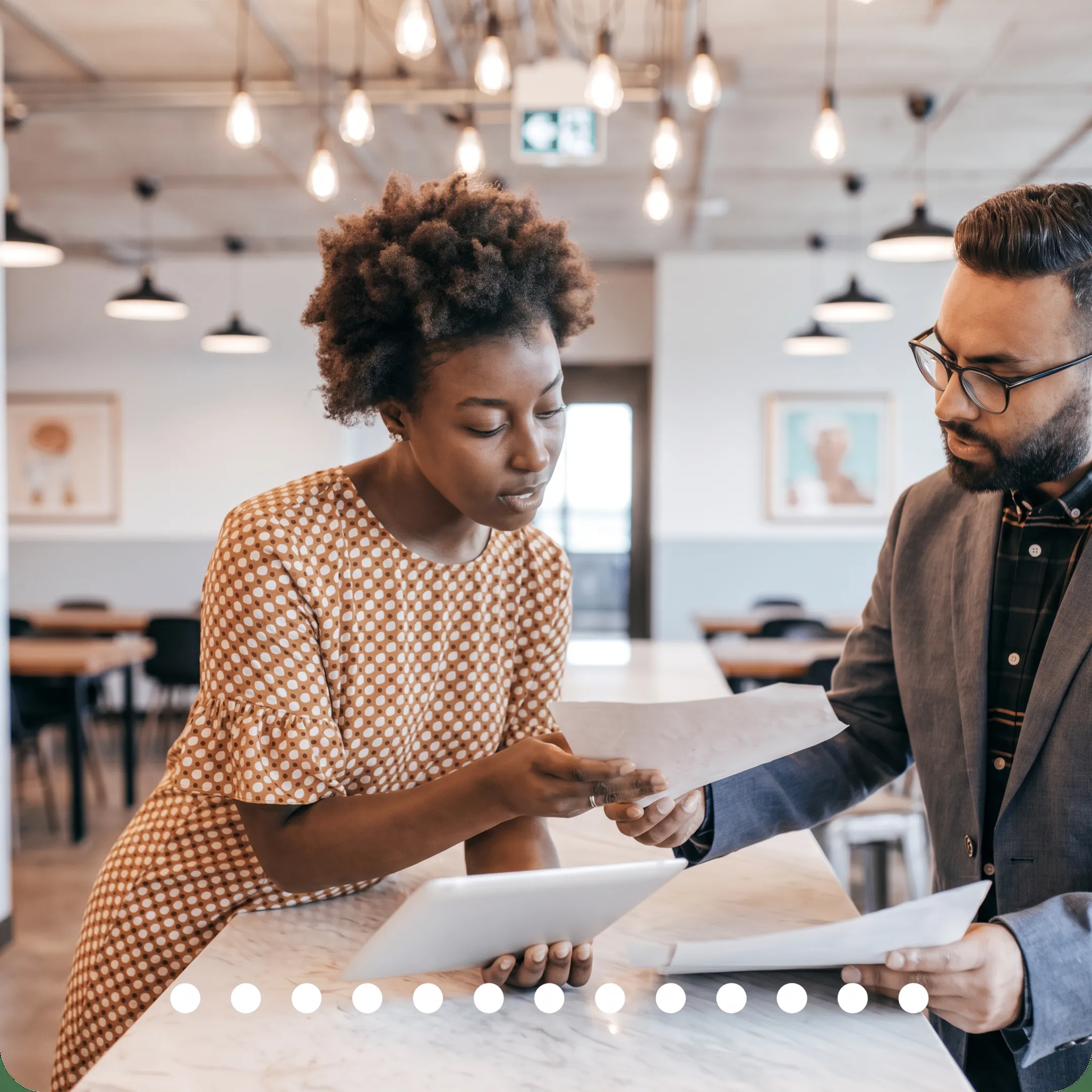 Advisor reviewing tax documents and financial reports with a business owner