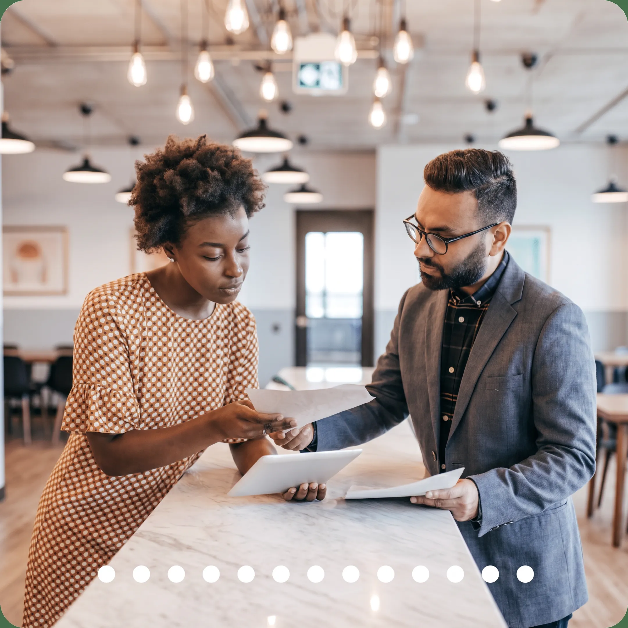 Advisor reviewing tax documents and financial reports with a business owner