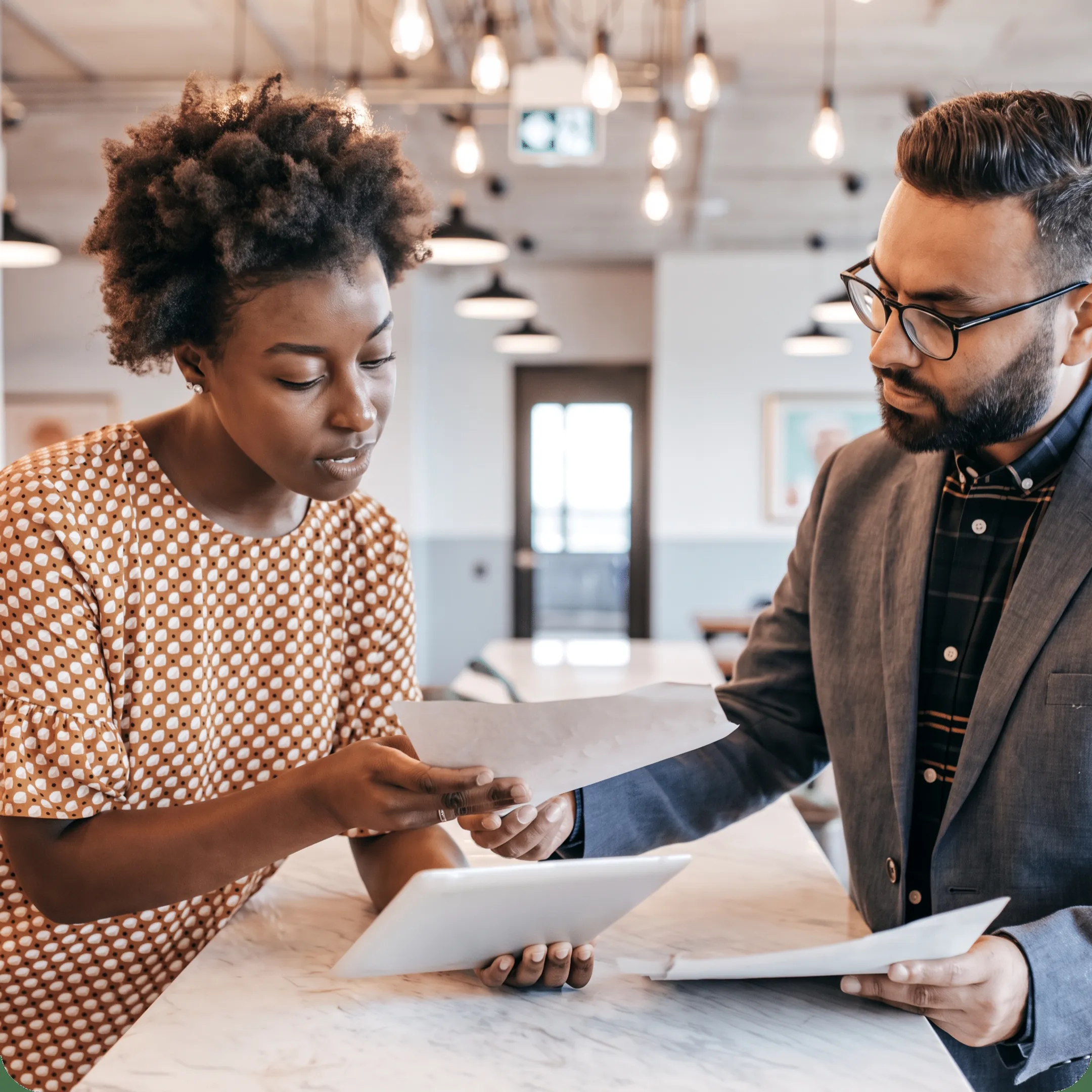 Advisor reviewing tax documents and financial reports with a business owner