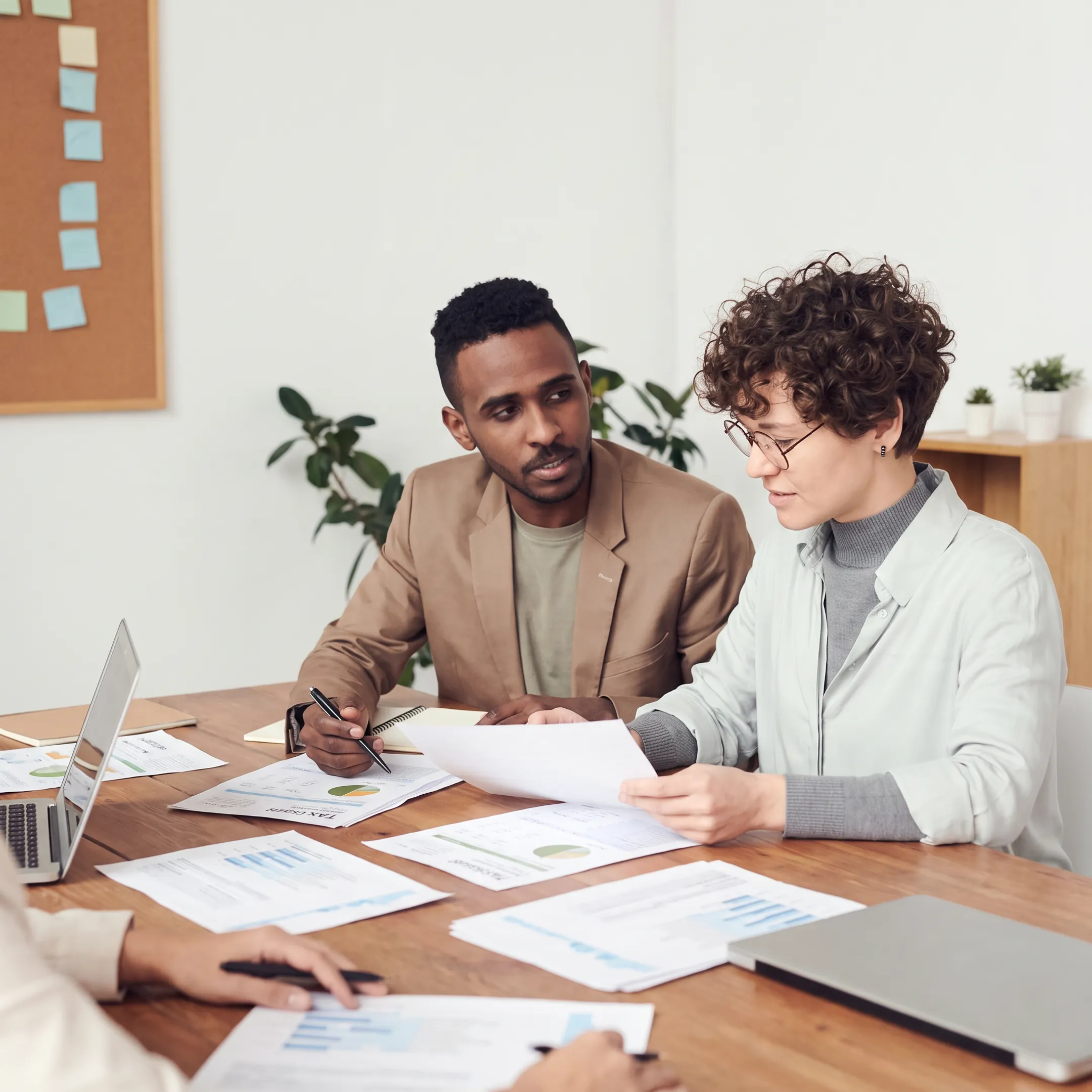 Accountant reviewing tax documents with a business owner in an office
