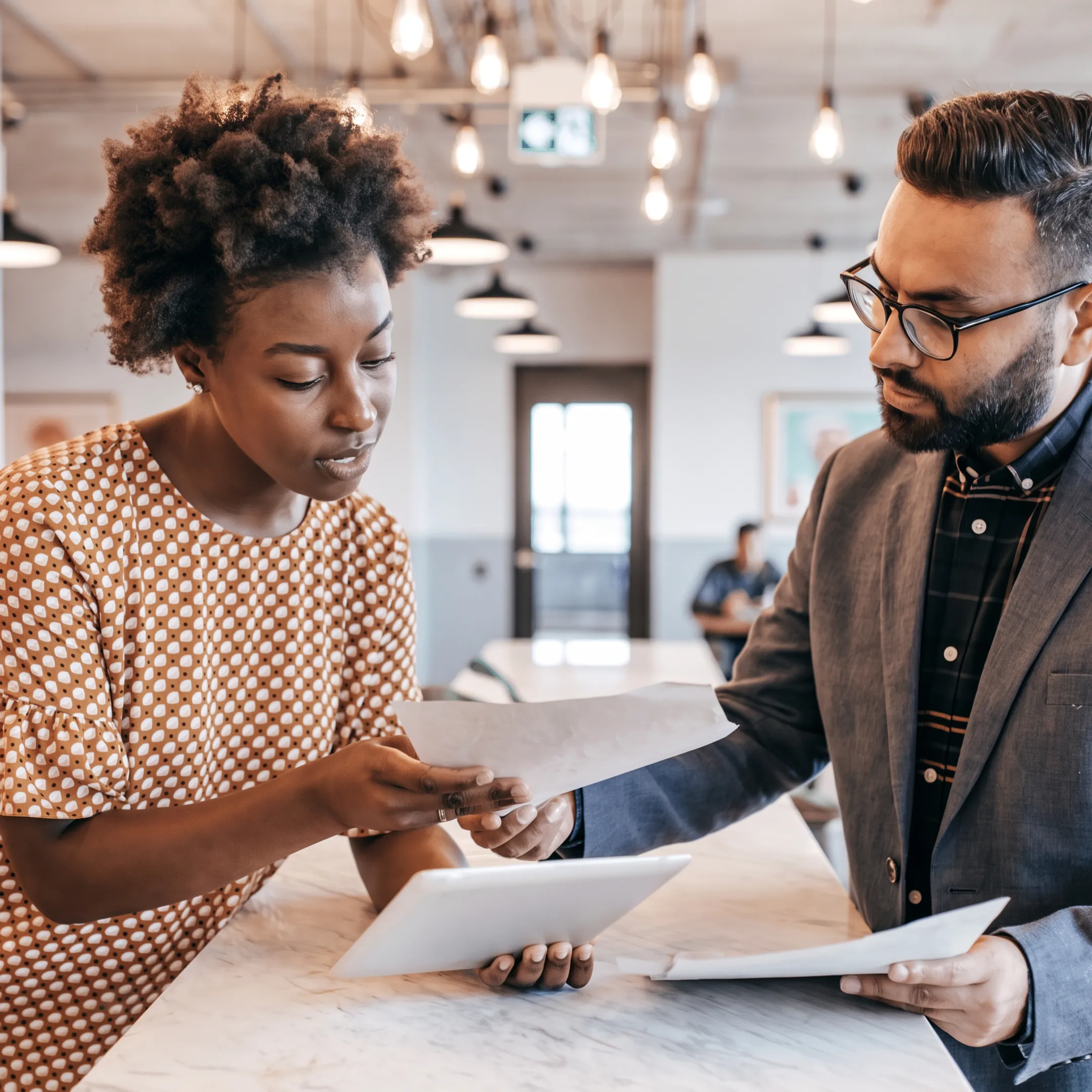 Advisor reviewing tax documents and financial reports with a business owner