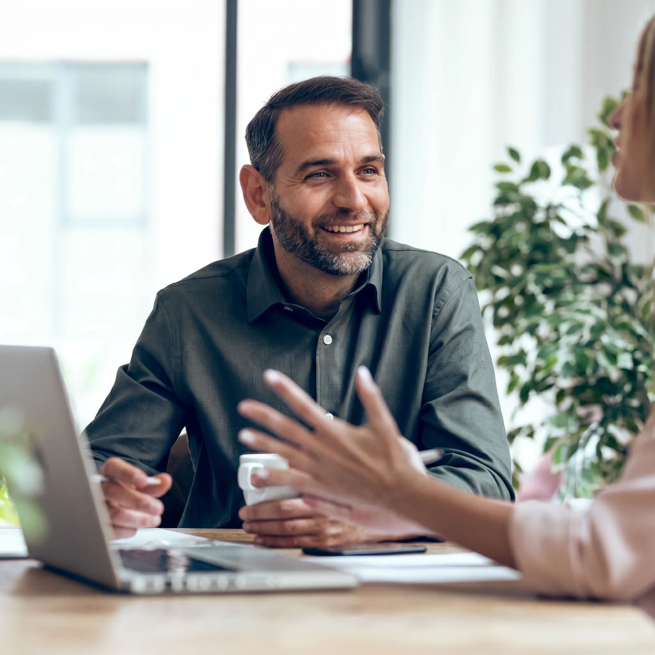 Financial advisor explaining bookkeeping and payroll reports to a business owner