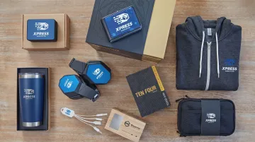 Branded employee swag kit with drinkware apparel and tech accessories for remote workers